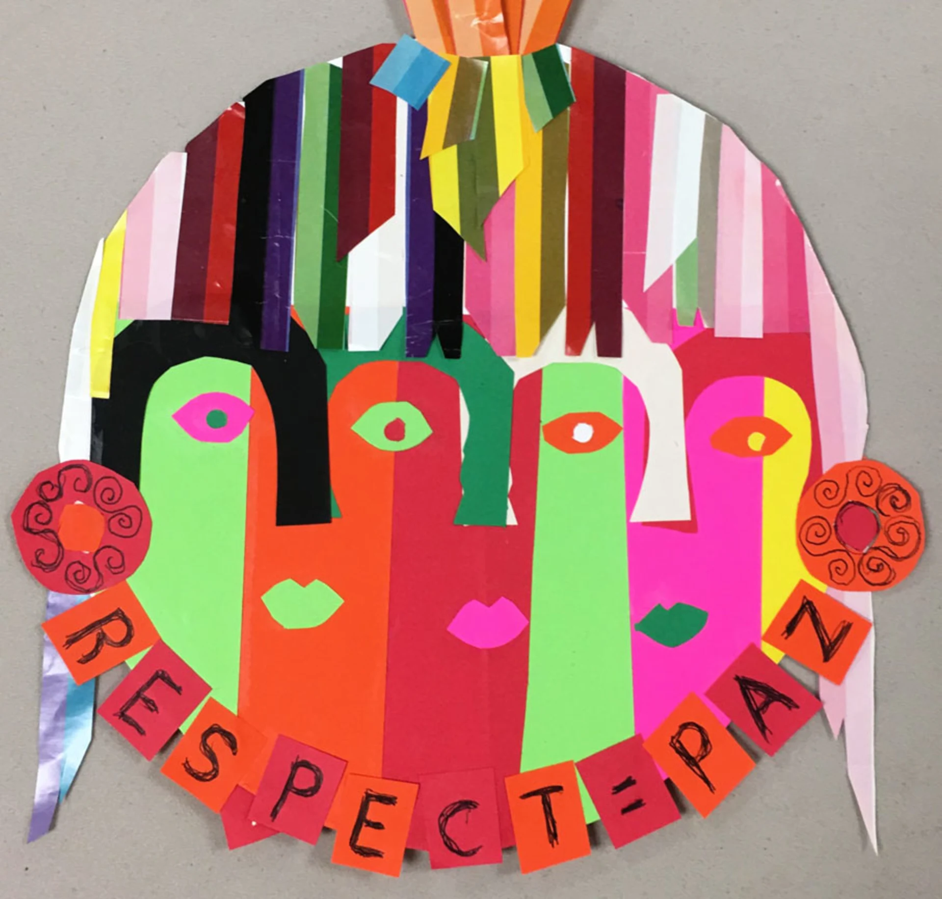 Colorful paper collage of three abstract faces merging into one with multicolored hair and the words 'Respect = Paz' across the bottom, where paz is the Spanish word for peace.