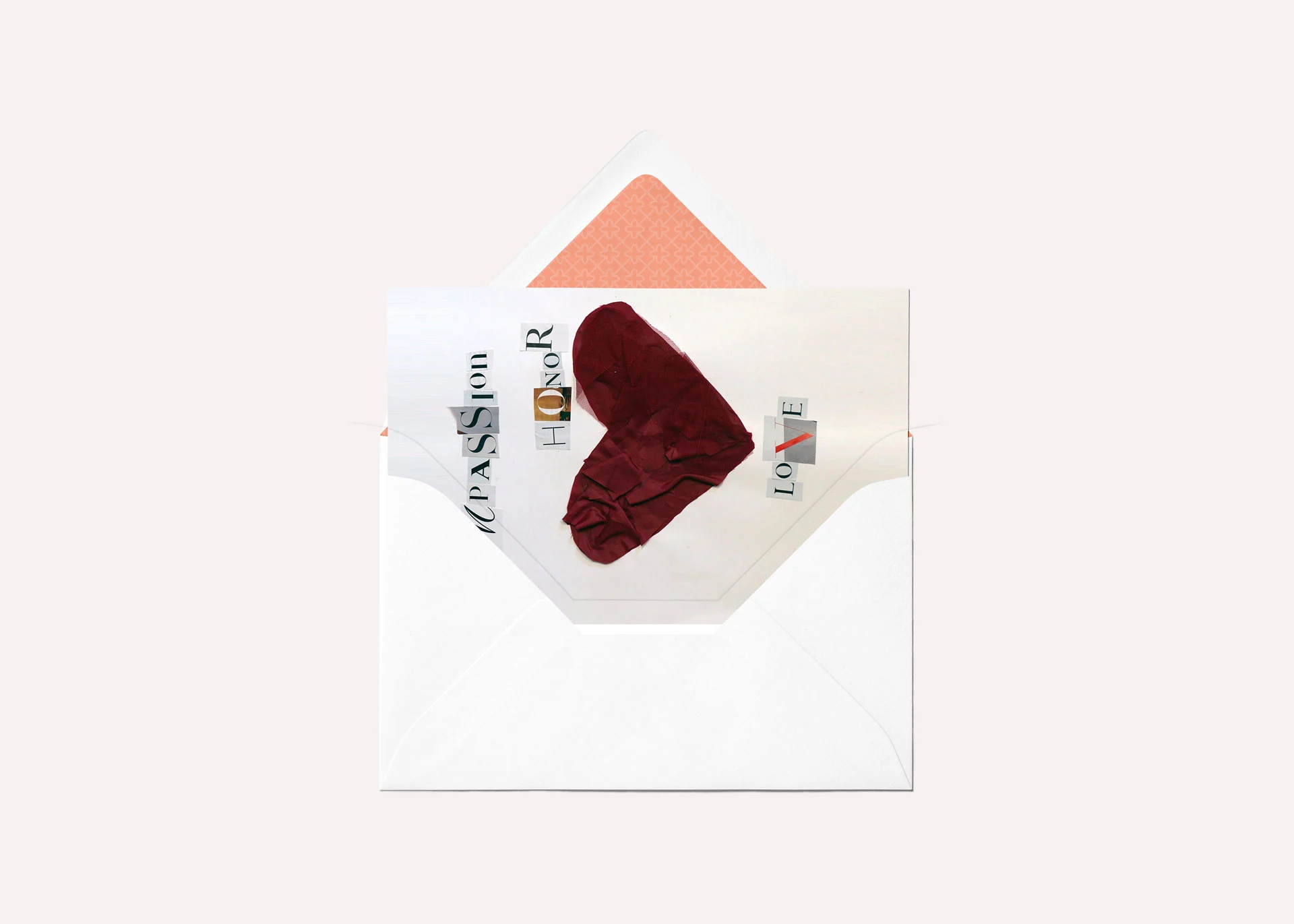 Greeting card mockup featuring a paper mâché heart and cutout letters spelling the words 'Compassion', 'Honor', and 'Love'.