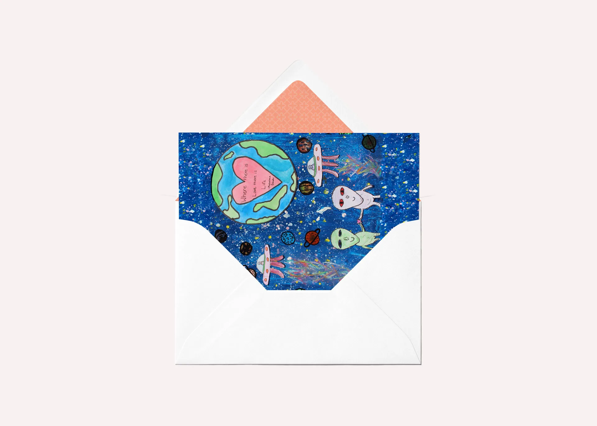 Greeting card mockup featuring an illustration of two aliens in outer space with space ships, the planet Earth, and a quote by Mahatma Gandhi in the background.
