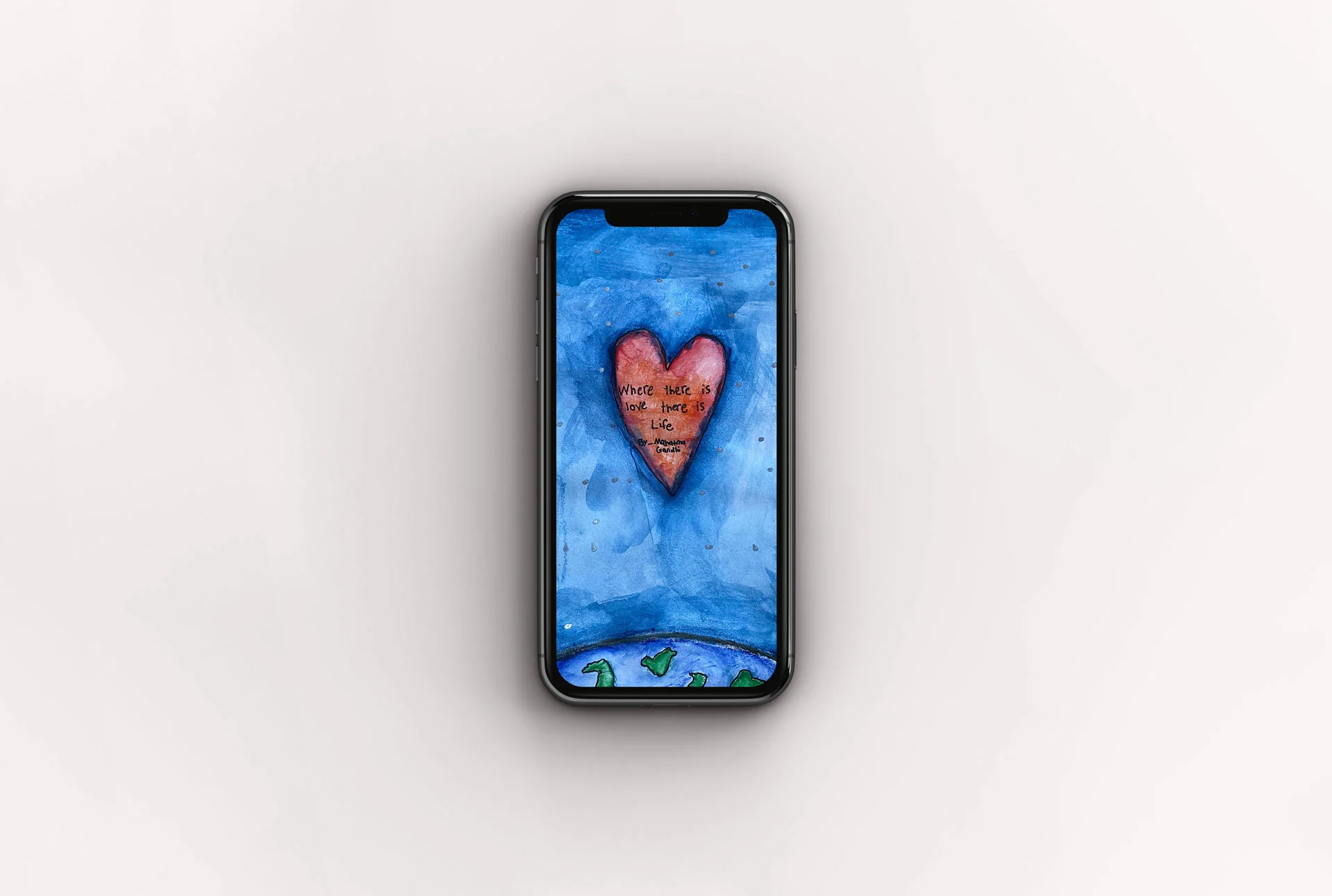 Phone wallpaper mockup featuring a watercolor of a heart floating in space between Earth and the sun with a quote by Mahatma Gandhi.
