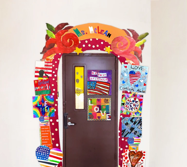The perimeter of a classroom door is decorated with dozens of square pieces of student artwork. At the top of the archway are multicolored letters that spell the name 'Ms. McClean.'