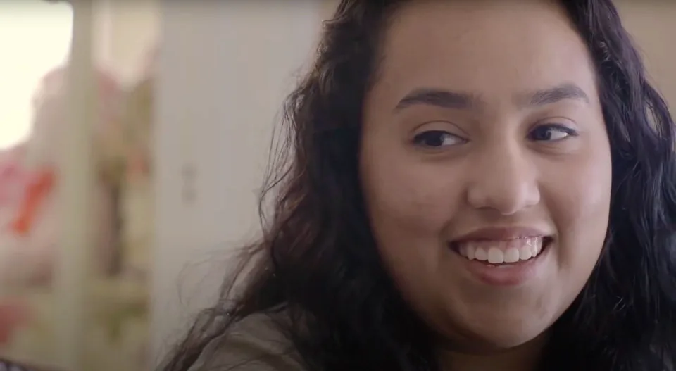 Close up of high school student Karina Muniz smiling in her home.