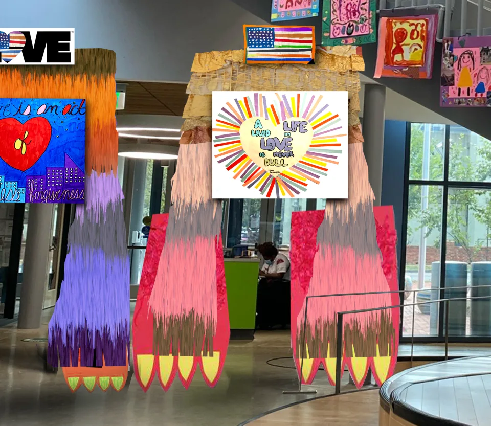 Giant, whimsical multicolored doorways featuring pictures of hearts, the American flag, and quotes about love in the middle of a school.